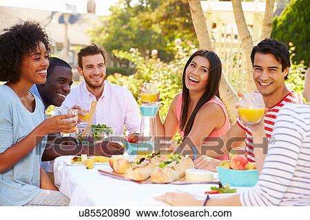 Group Of Friends Enjoying Meal At Outdoor Party In Back Yard View Large Photo Image Stock Image - Group Of Friends Enjoying Meal At Outdoor Party In Back Yard. Fotosearch