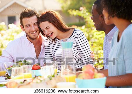 Group Of Friends Enjoying Meal At Outdoor Party In Back Yard View Large Photo Image Stock Photo - Group Of Friends Enjoying Meal At Outdoor Party In Back Yard. Fotosearch