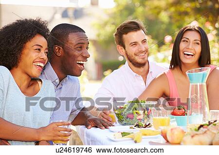 Group Of Friends Enjoying Meal At Outdoor Party In Back Yard View Large Photo Image Stock Photograph - Group Of Friends Enjoying Meal At Outdoor Party In Back Yard. Fotosearch