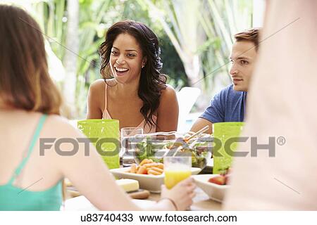Group Of Friends Enjoying Meal Outdoors At Home View Large Photo Image Stock Image - Group Of Friends Enjoying Meal Outdoors At Home. Fotosearch