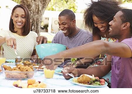 Group Of Friends Enjoying Outdoor Meal At Home View Large Photo Image Stock Photo - Group Of Friends Enjoying Outdoor Meal At Home. Fotosearch