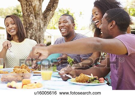 Group Of Friends Enjoying Outdoor Meal At Home View Large Photo Image Stock Photograph - Group Of Friends Enjoying Outdoor Meal At Home. Fotosearch