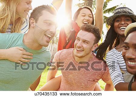 Stock Image - Group Of Friends Having Fun In Park Together. Fotosearch
