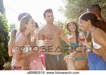Stock Photo - Group Of Friends Having Party By Swimming Pool. Fotosearch