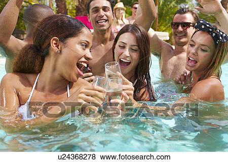 Stock Photo - Group Of Friends Having Party In Pool Drinking Champagne. Fotosearch