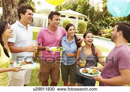 Stock Image - Group Of Friends Having Party In Backyard At Home. Fotosearch