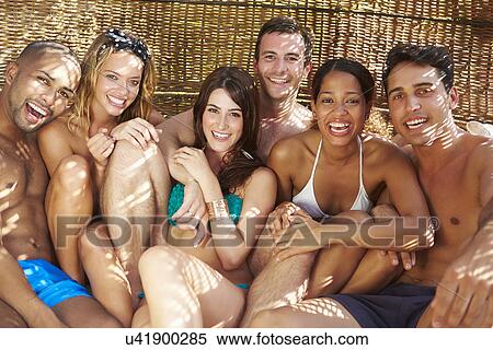 Group Of Friends In Swimwear Relaxing Outdoors Together View Large Photo Image Stock Photography - Group Of Friends In Swimwear Relaxing Outdoors Together. Fotosearch