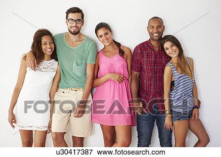 Group Of Friends Leaning Against White Wall View Large Photo Image Stock Photo - Group Of Friends Leaning Against White Wall. Fotosearch