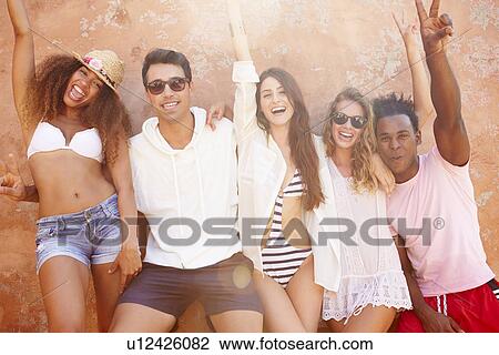 Group Of Friends On Holiday Together Posing By Wall View Large Photo Image Stock Image - Group Of Friends On Holiday Together Posing By Wall. Fotosearch