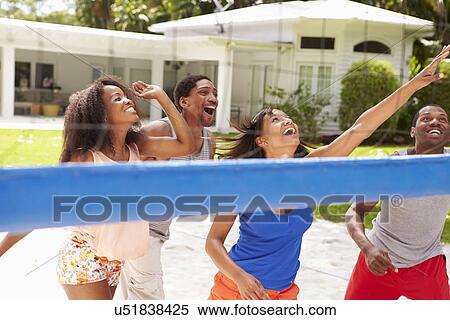 Stock Photography - Group Of Friends Playing Volleyball Match. Fotosearch