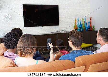Group Of Friends Sitting On Sofa Watching TV Together View Large Photo Image Picture - Group Of Friends Sitting On Sofa Watching TV Together. Fotosearch