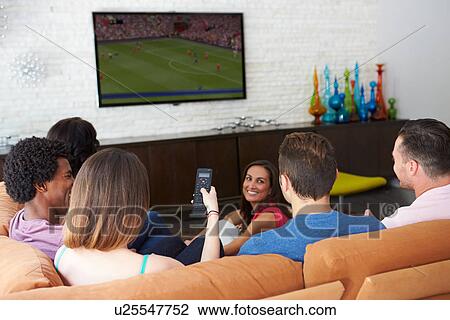 Group Of Friends Sitting On Sofa Watching Soccer Together View Large Photo Image Stock Image - Group Of Friends Sitting On Sofa Watching Soccer Together. Fotosearch