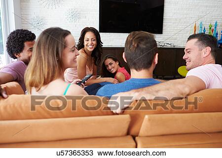 Group Of Friends Sitting On Sofa Watching TV Together View Large Photo Image Stock Image - Group Of Friends Sitting On Sofa Watching TV Together. Fotosearch