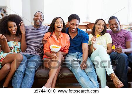 Group Of Friends Sitting On Sofa Watching TV Together View Large Photo Image Stock Image - Group Of Friends Sitting On Sofa Watching TV Together. Fotosearch