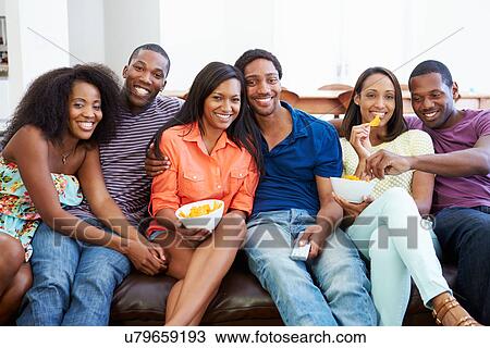Group Of Friends Sitting On Sofa Watching TV Together View Large Photo Image Stock Image - Group Of Friends Sitting On Sofa Watching TV Together. Fotosearch