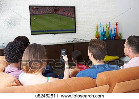 Group Of Friends Sitting On Sofa Watching Soccer Together View Large Photo Image Stock Image - Group Of Friends Sitting On Sofa Watching Soccer Together. Fotosearch