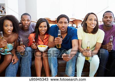 Group Of Friends Sitting On Sofa Watching TV Together View Large Photo Image Stock Image - Group Of Friends Sitting On Sofa Watching TV Together. Fotosearch