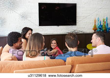 Group Of Friends Sitting On Sofa Watching TV Together View Large Photo Image Stock Photo - Group Of Friends Sitting On Sofa Watching TV Together. Fotosearch