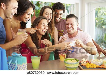 Stock Photo - Group Of Friends Taking Selfie Whilst Celebrating Birthday . Fotosearch