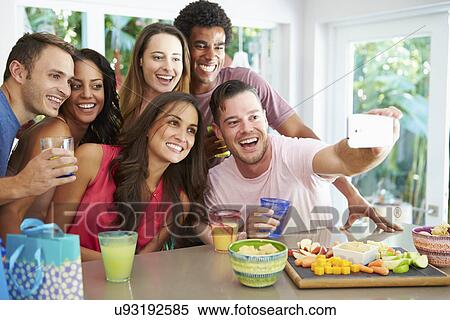 Group Of Friends Taking Selfie Whilst Celebrating Birthday View Large Photo Image Stock Photography - Group Of Friends Taking Selfie Whilst Celebrating Birthday . Fotosearch