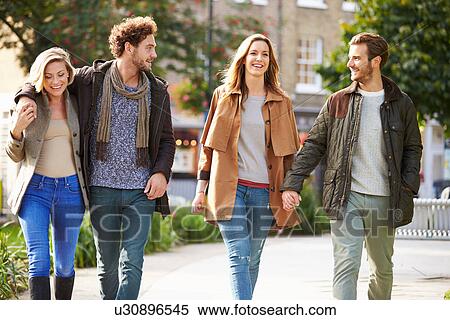 Stock Photography - Group Of Friends Walking Through City Park Together. Fotosearch