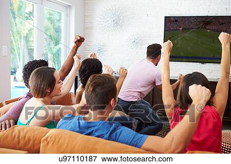 Stock Photo - Group Of Friends Watching Soccer Celebrating Goal. Fotosearch
