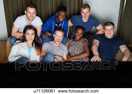 Group Of Friends Watching Television At Home Together View Large Photo Image Stock Image - Group Of Friends Watching Television At Home Together. Fotosearch