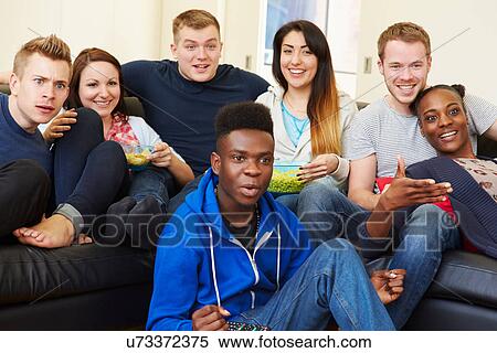 Group Of Friends Watching Television At Home Together View Large Photo Image Stock Photography - Group Of Friends Watching Television At Home Together. Fotosearch