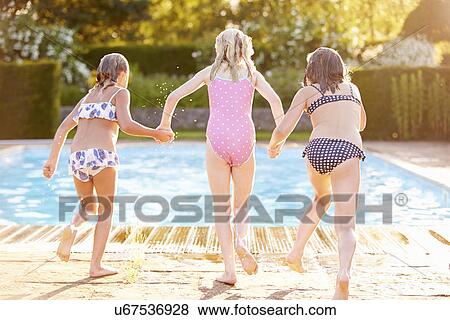 Group Of Girls Jumping Into Outdoor Swimming Pool View Large Photo Image Stock Photo - Group Of Girls Jumping Into Outdoor Swimming Pool. Fotosearch