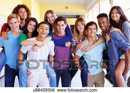 Stock Photo - Group Of High School Students Giving Piggybacks In Corridor. Fotosearch