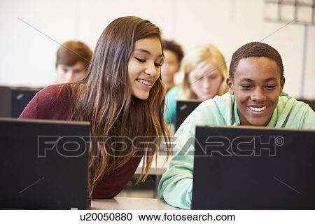 Stock Image - Group Of High School Students In Class Using Laptops. Fotosearch