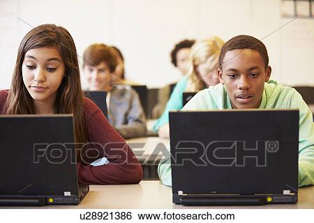 Stock Photograph - Group Of High School Students In Class Using Laptops. Fotosearch