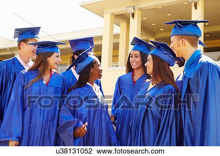 Stock Image - Group Of High School Students Celebrating Graduation. Fotosearch