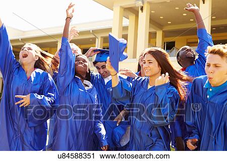 Stock Image - Group Of High School Students Celebrating Graduation. Fotosearch