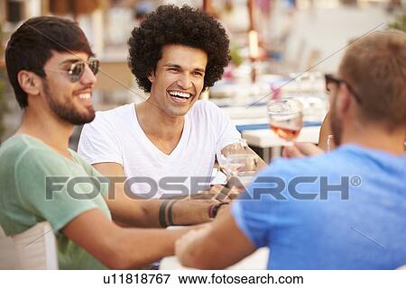 Group Of Male Friends Enjoying Meal In Outdoor Restaurant View Large Photo Image Stock Photo - Group Of Male Friends Enjoying Meal In Outdoor Restaurant. Fotosearch