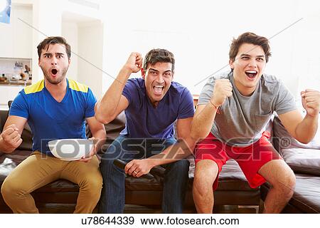 Group Of Men Sitting On Sofa Watching Sport Together View Large Photo Image Stock Photo - Group Of Men Sitting On Sofa Watching Sport Together. Fotosearch