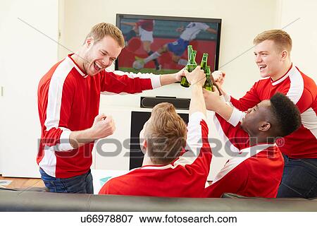 Group Of Sports Fans Watching Game On TV At Home View Large Photo Image Stock Photo - Group Of Sports Fans Watching Game On TV At Home. Fotosearch