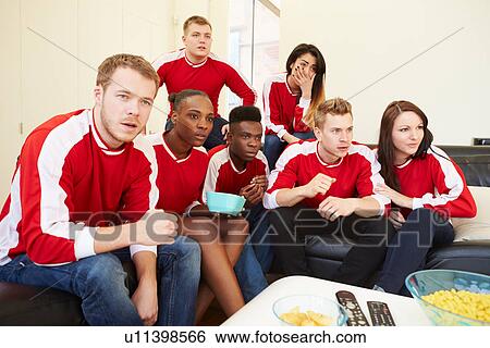 Stock Photograph - Group Of Sports Fans Watching Game On TV At Home. Fotosearch