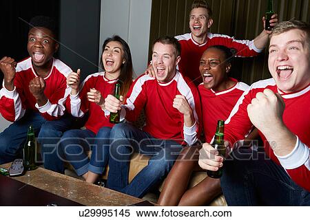 Stock Photography - Group Of Sports Fans Watching Game On TV At Home. Fotosearch