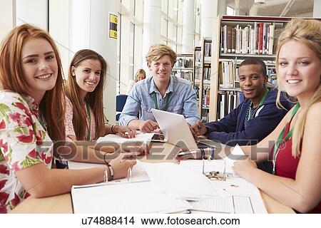 Picture - Group Of Students Working Together In Library. Fotosearch