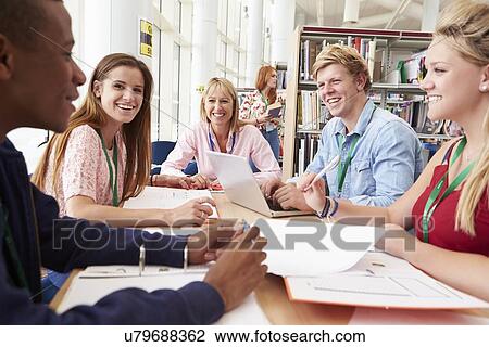 Group Of Students Working Together In Library With Teacher View Large Photo Image Stock Image - Group Of Students Working Together In Library With Teacher. Fotosearch