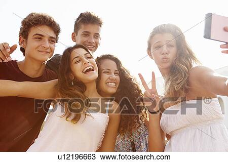 Group Of Teenage Friends Dancing And Taking Selfie View Large Photo Image Stock Image - Group Of Teenage Friends Dancing And Taking Selfie . Fotosearch