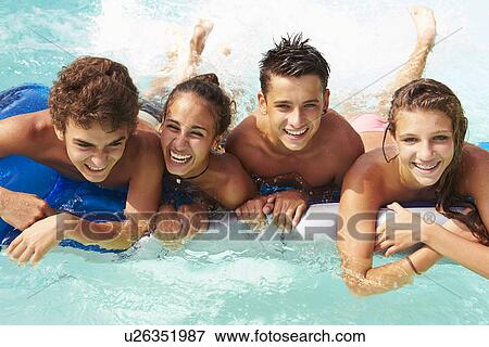 Group Of Teenage Friends Having Fun In Swimming Pool View Large Photo Image Stock Photo - Group Of Teenage Friends Having Fun In Swimming Pool. Fotosearch