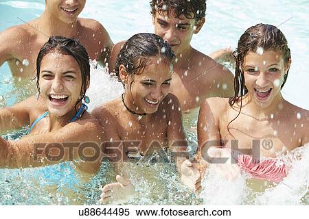 Group Of Teenage Friends Having Fun In Swimming Pool View Large Photo Image Stock Photography - Group Of Teenage Friends Having Fun In Swimming Pool. Fotosearch