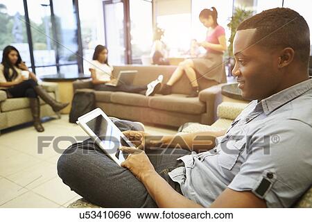 Stock Photograph - Group Of University Students Relaxing In Common Room. Fotosearch