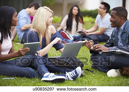 Group Of University Students Working Outside Together View Large Photo Image Stock Photo - Group Of University Students Working Outside Together. Fotosearch