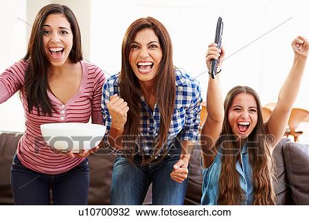 Group Of Women Sitting On Sofa Watching Sport Together View Large Photo Image Stock Image - Group Of Women Sitting On Sofa Watching Sport Together. Fotosearch