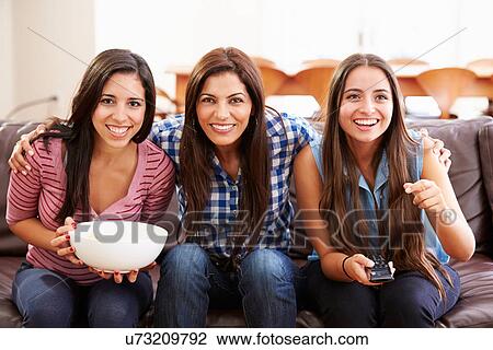 Group Of Women Sitting On Sofa Watching Sport Together View Large Photo Image Stock Image - Group Of Women Sitting On Sofa Watching Sport Together. Fotosearch