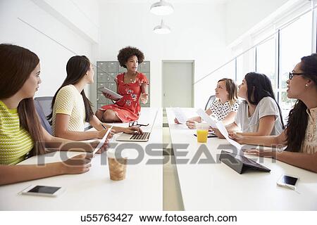 Group Of Women Working Together In Design Studio View Large Photo Image Stock Photo - Group Of Women Working Together In Design Studio. Fotosearch