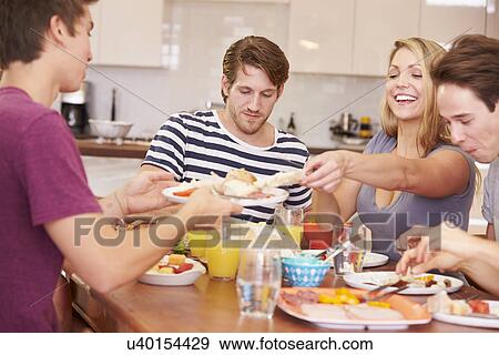 Group Of Young Friends Enjoying Meal At Home View Large Photo Image Stock Photo - Group Of Young Friends Enjoying Meal At Home. Fotosearch
